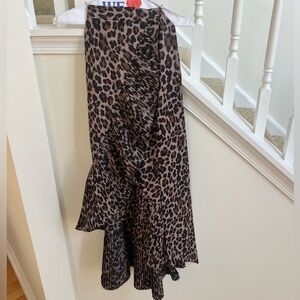 This is a brown leopard print midi or maxi skirt with ruffle and pleat details.